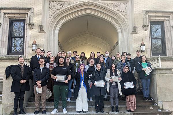 Paticipants in the 2024 Undergraduate Olympiada of Spoken Russian share their certificates in front of Kauke Hall at the College of Wooster