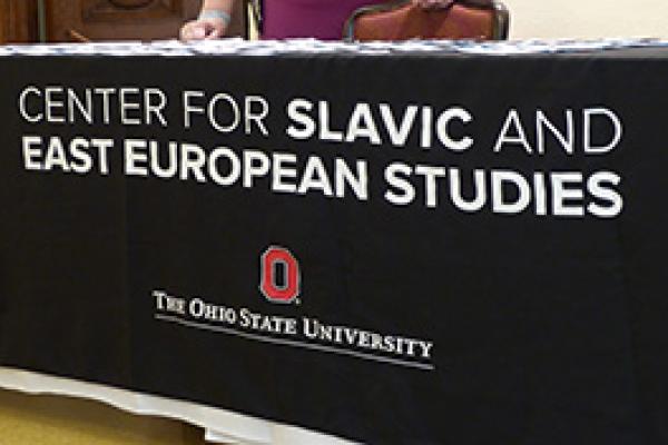 A black tablecloth with white text "Center for Slavic and East European Studies"