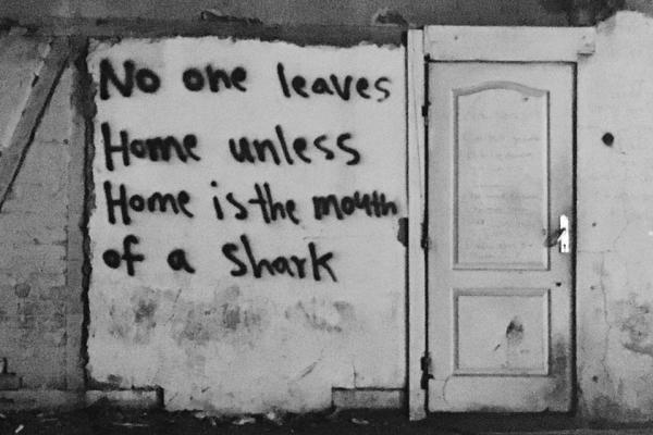 No One Leaves Home Unless Home is the Mouth of a Shark graffiti on a building 