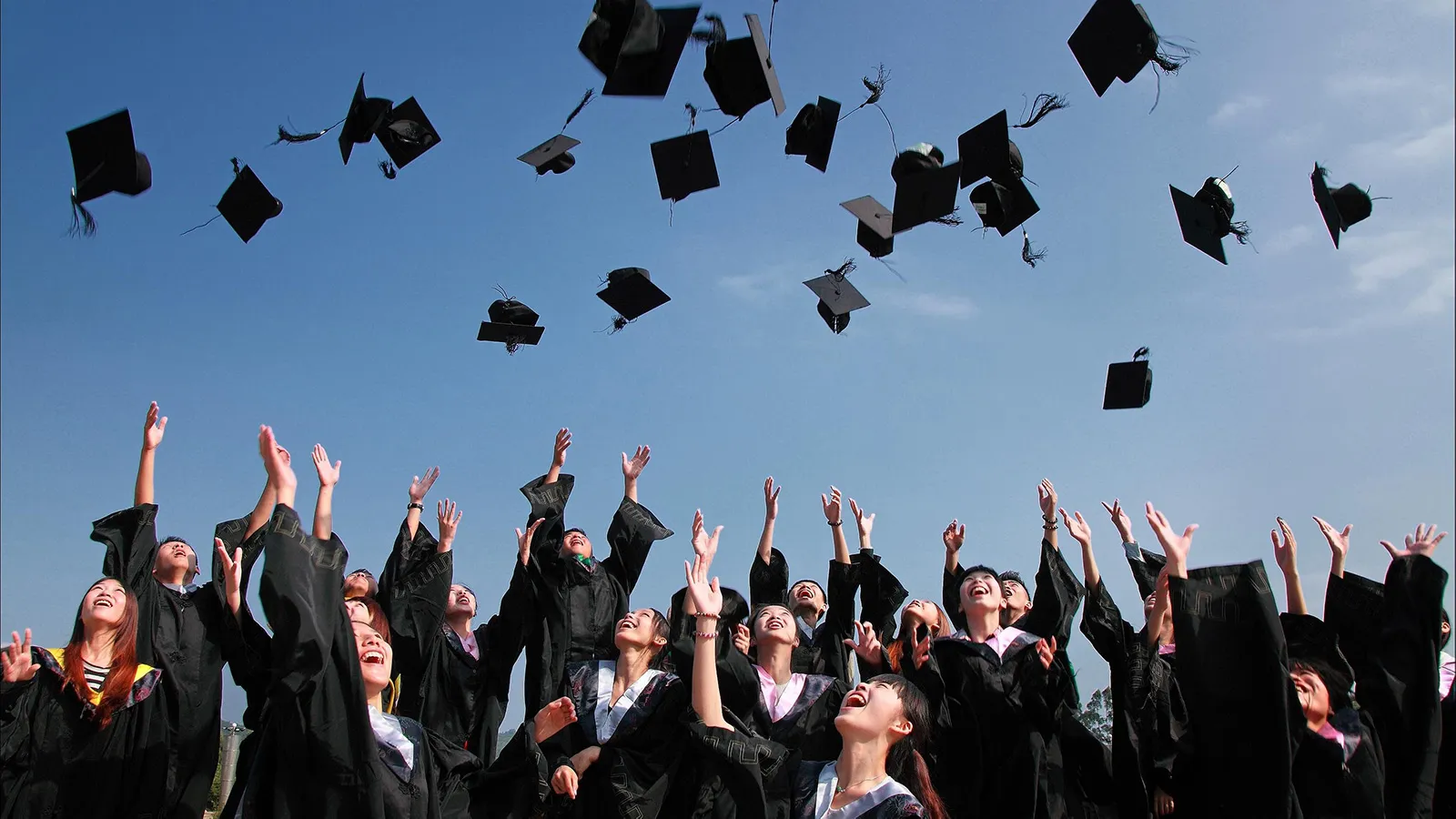 Graduates throwing up hats