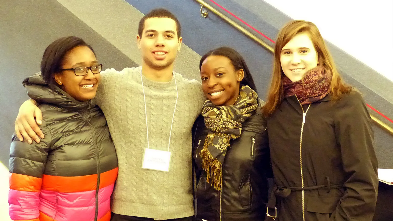 Four students standing in hallway