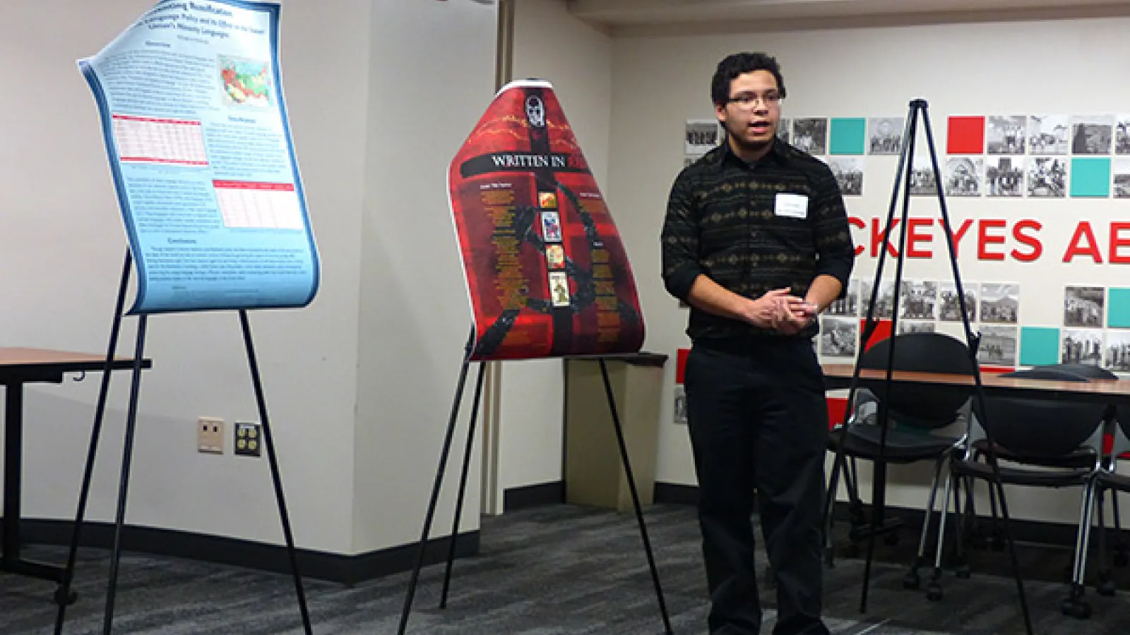 Student standing by poster