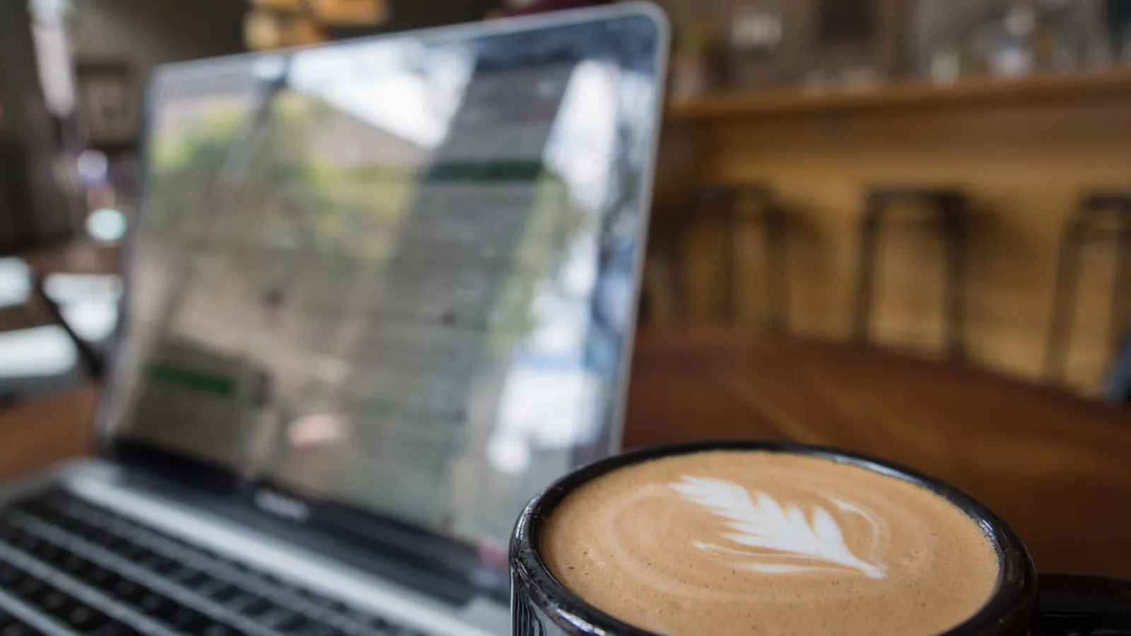 open laptop and coffee cup on a desk