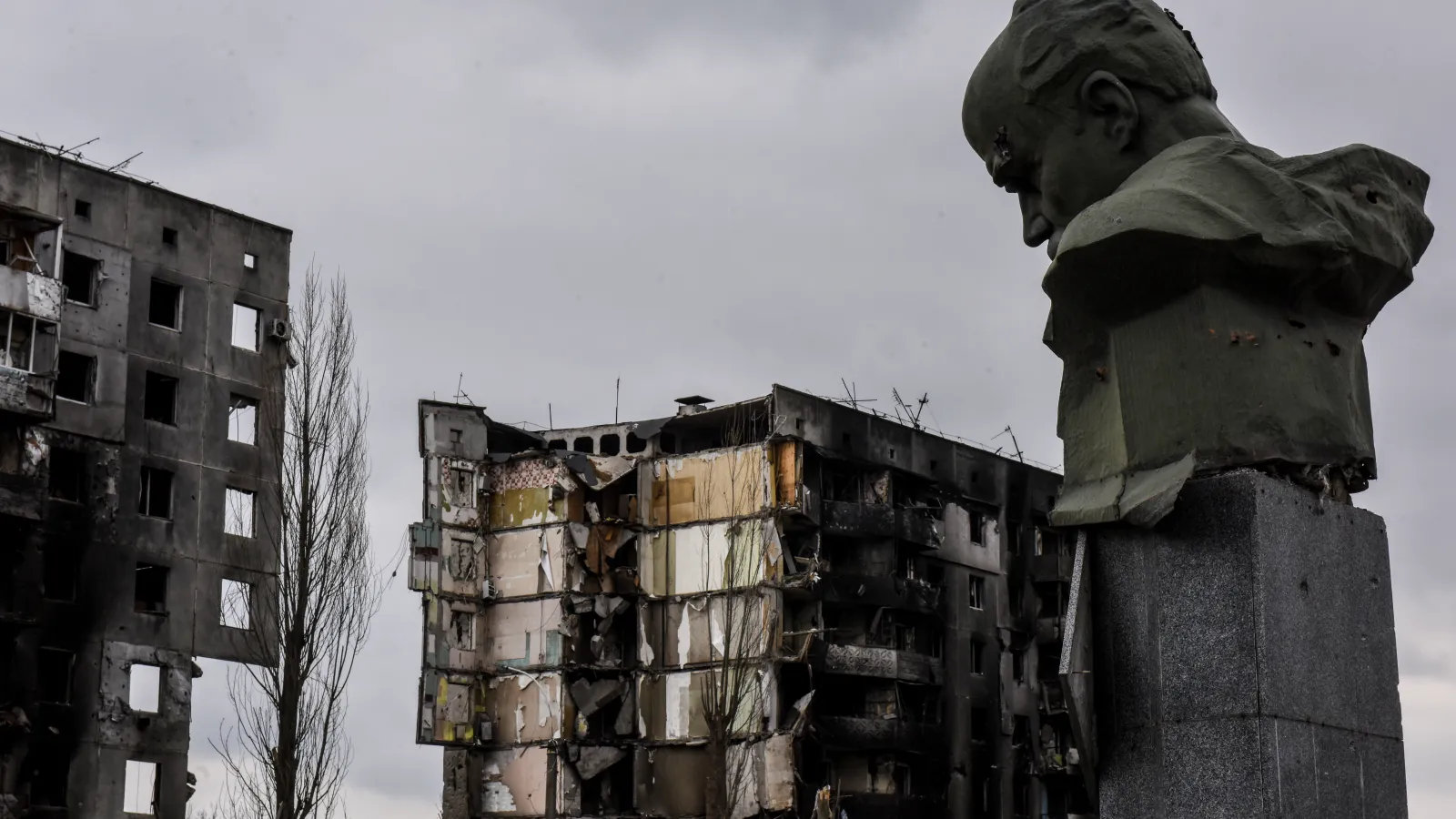 Bust of Taras Shevchenko in front of the remains of buildings in in Borodyanka. 