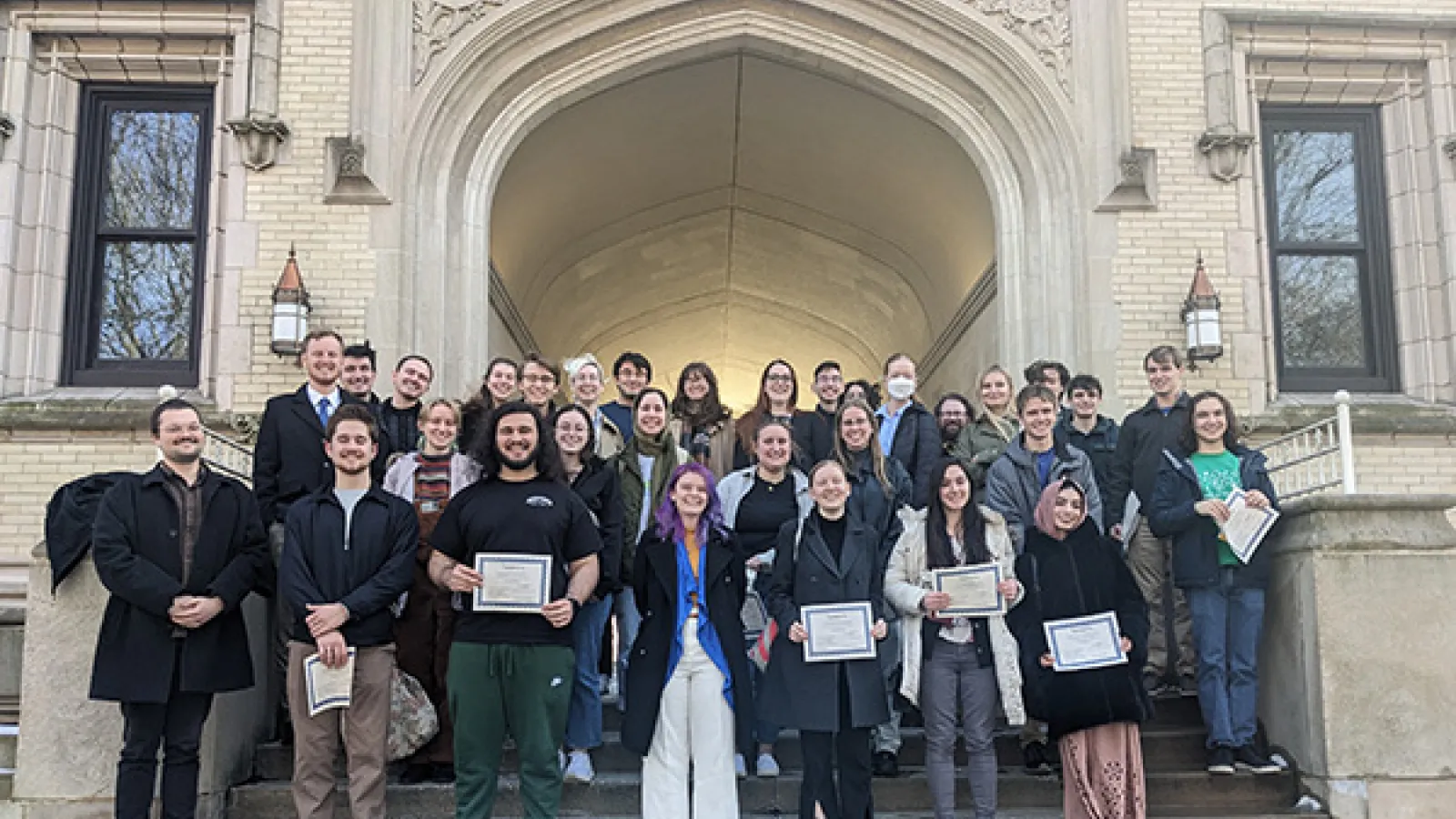 Paticipants in the 2024 Undergraduate Olympiada of Spoken Russian share their certificates in front of Kauke Hall at the College of Wooster