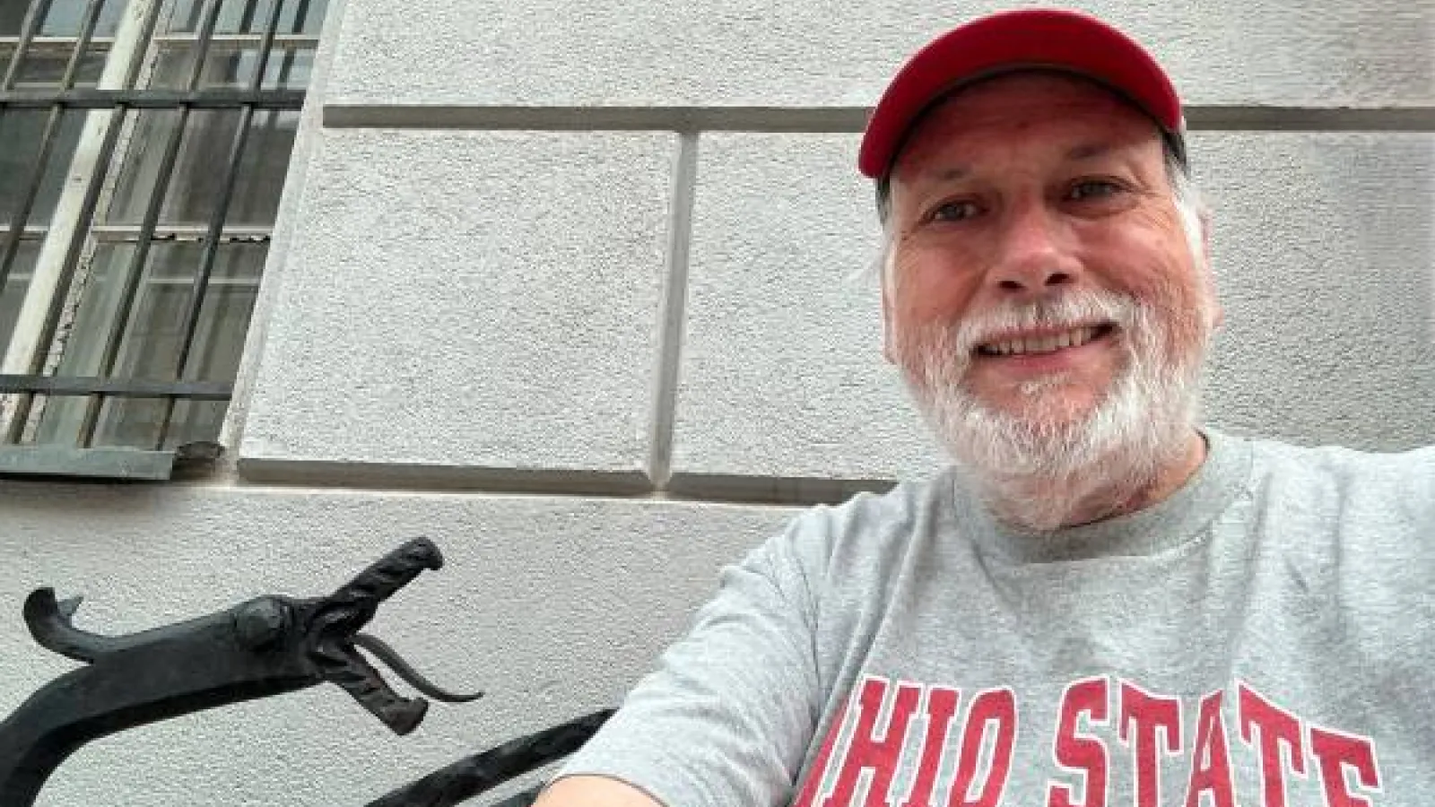 Richard Pratt in Ljubljana, Slovenia with a dragon sculpture