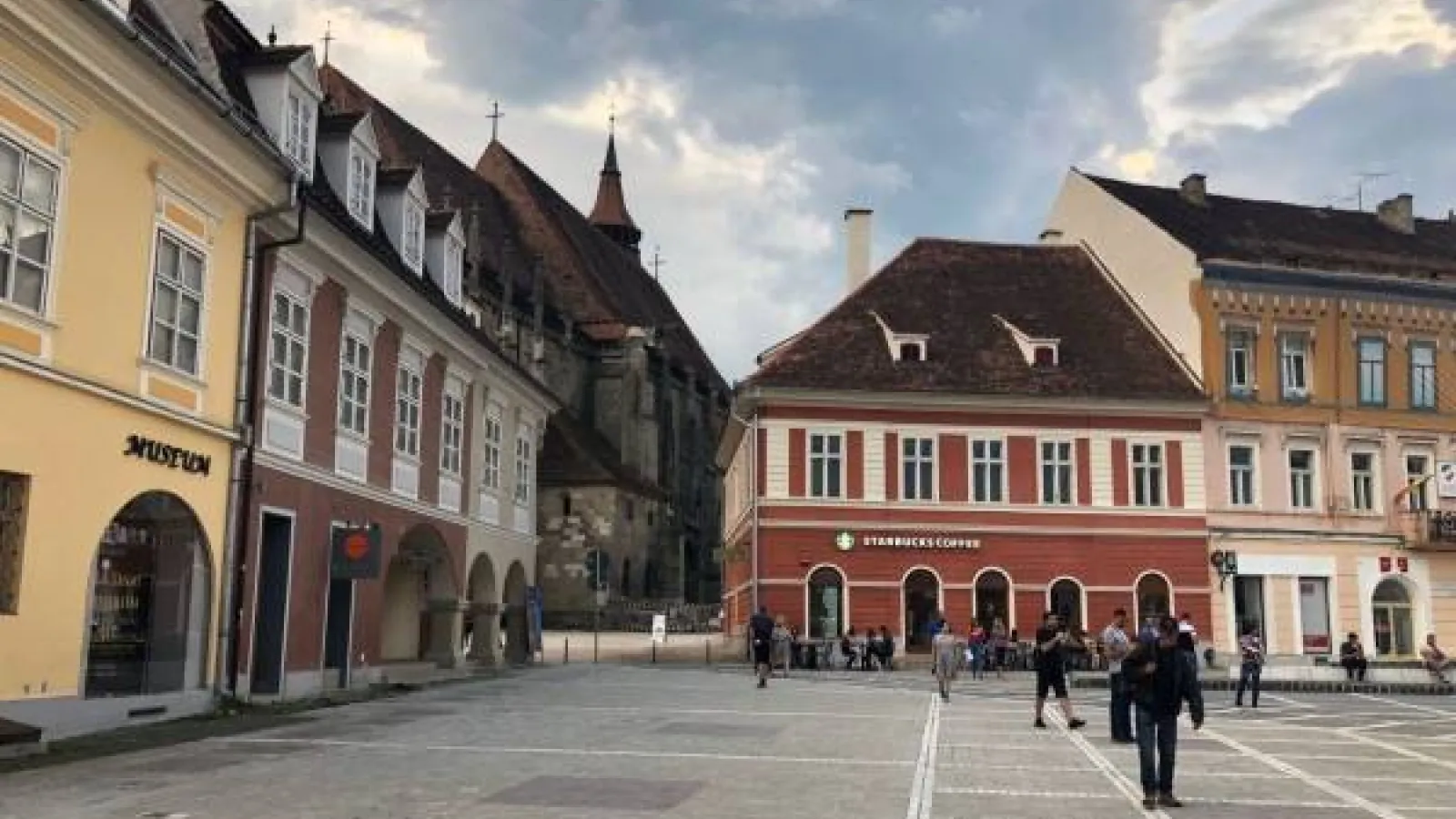 The city of Sibiu, Romania, featuring an old square with a Starbucks coffee shop