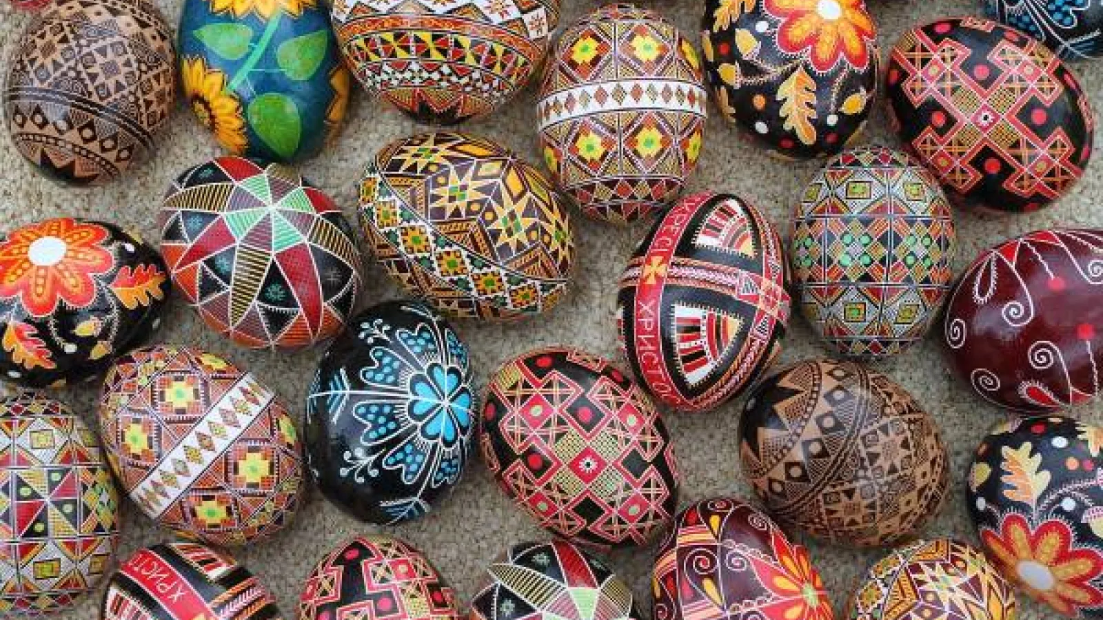 An assortment of colorful eggs decorated in Ukrianian wax relief with both traditional and modern motifs