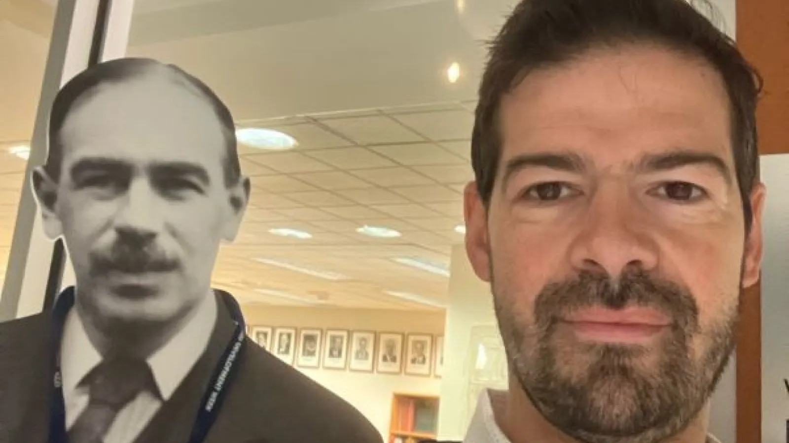 Artemy Kalinovsky (brown eyes, beard) poses in a museum with a cardboard cutout