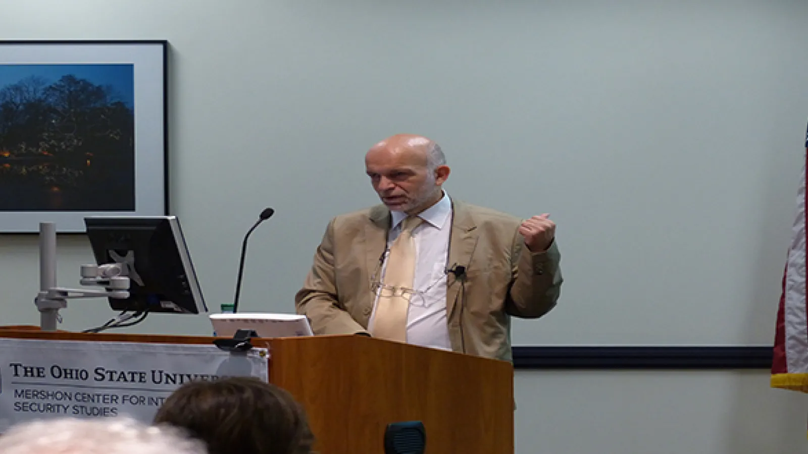 Man standing at podium talking