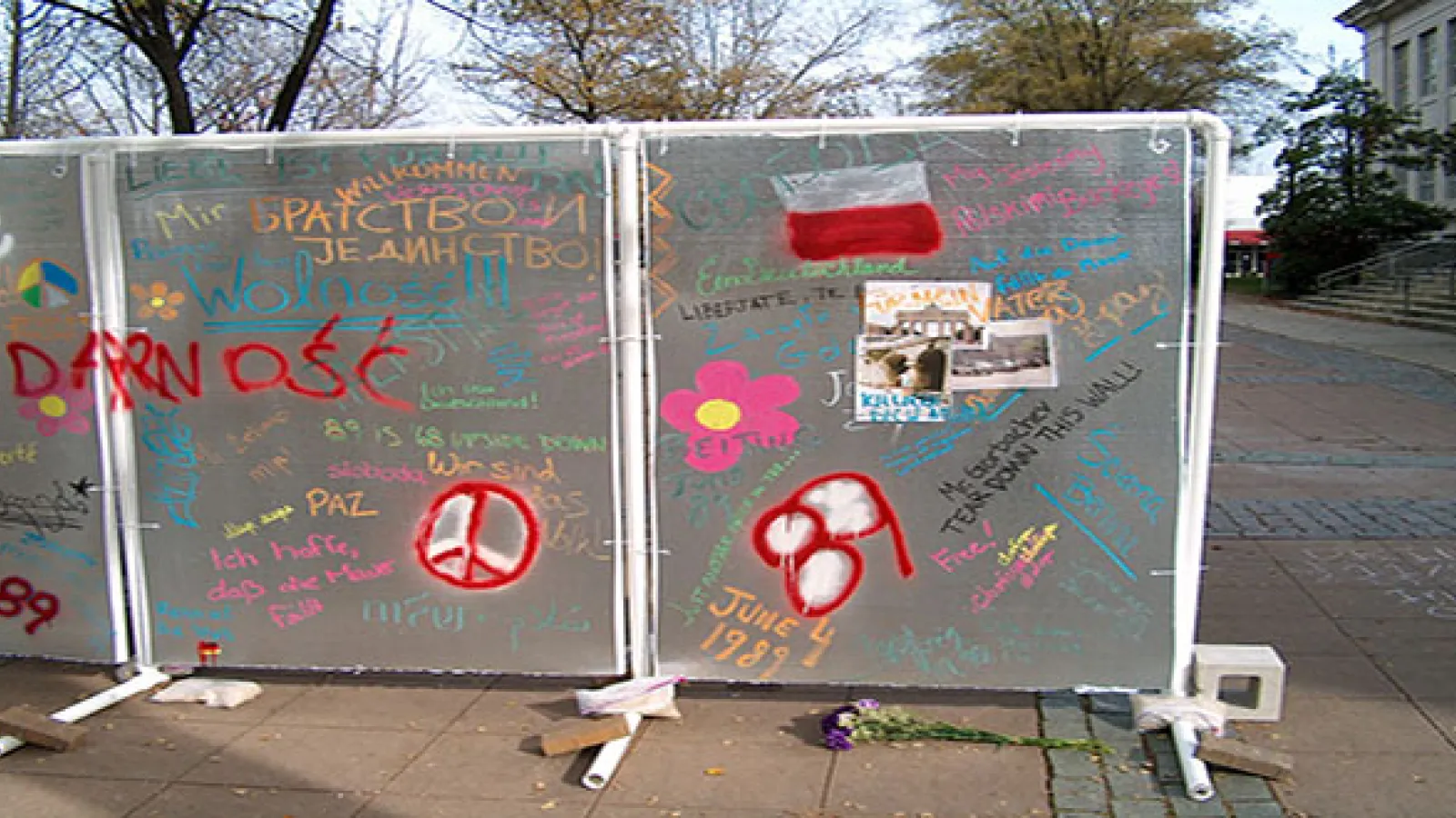 Silver upright panels covered in writing and paint