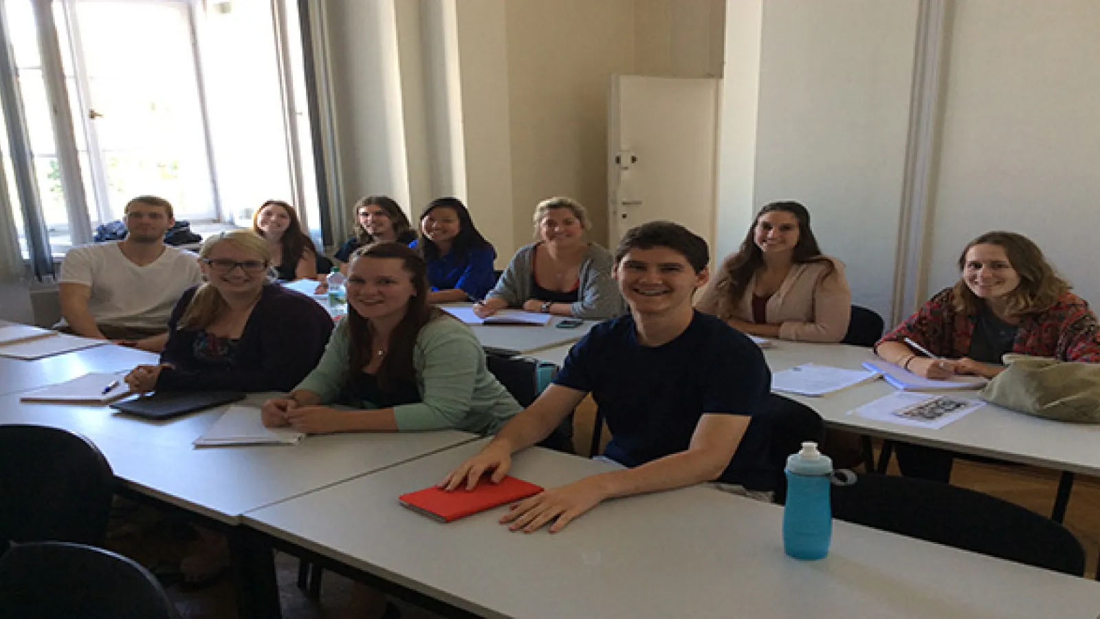 Students sitting at tables in rows