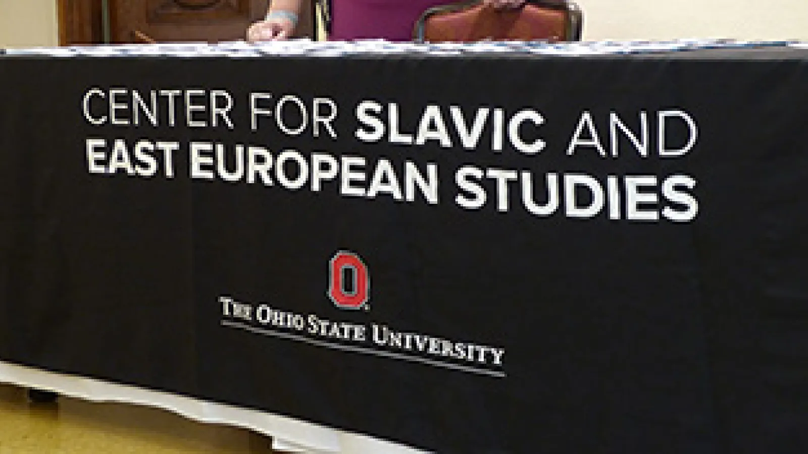 A black tablecloth with white text "Center for Slavic and East European Studies"