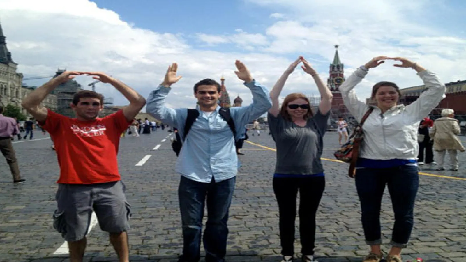 4 students standing side-by-side forming O-H-I-O