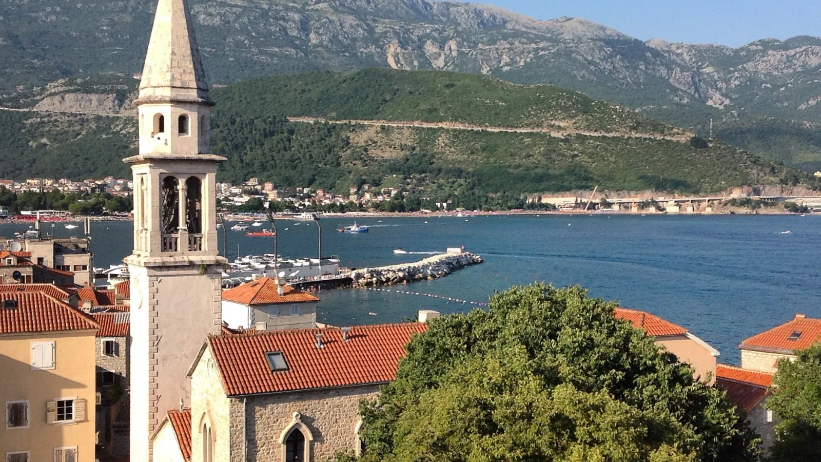 View overlooking a city on a bay with mountains in the background