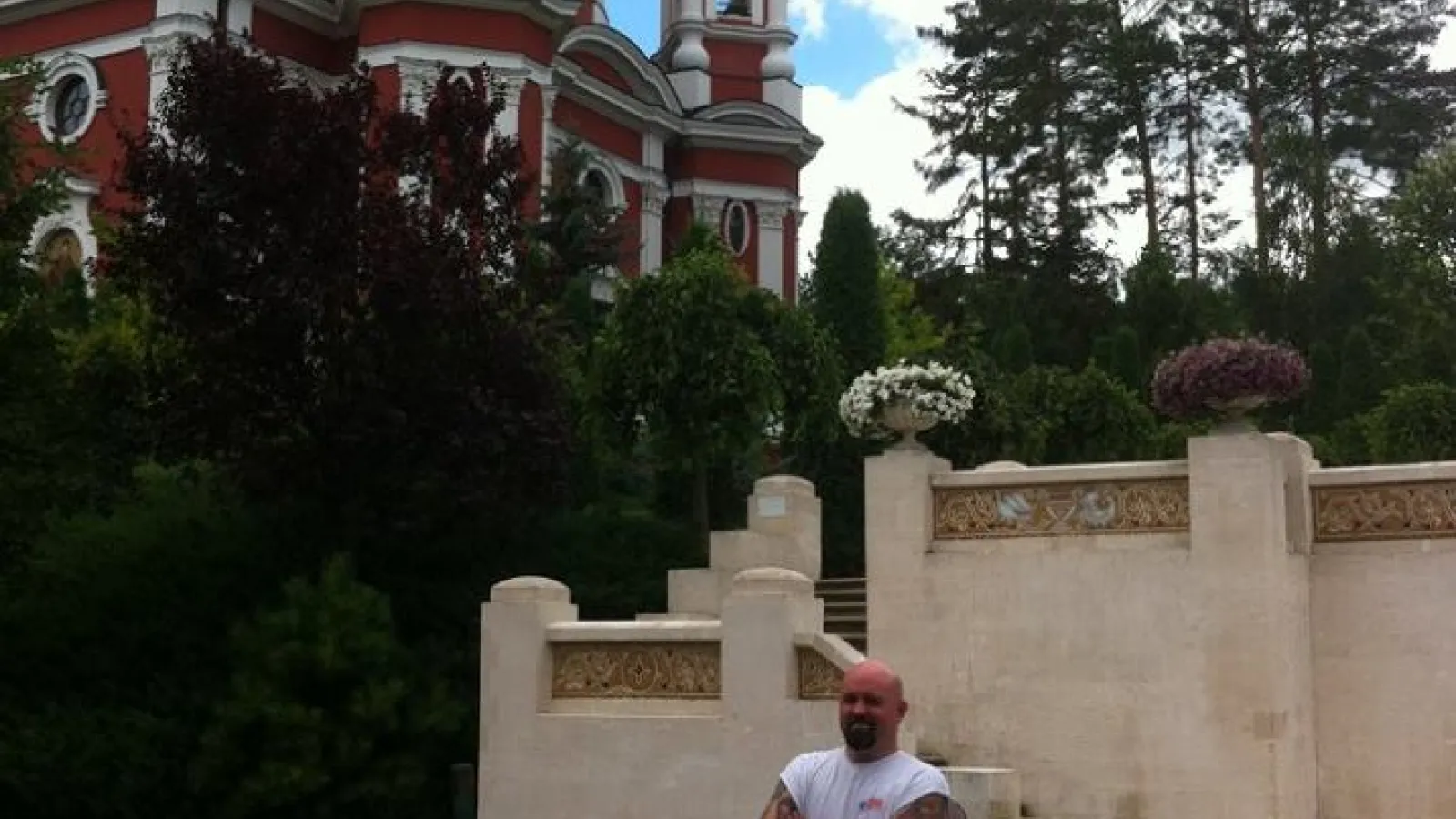 Justin standing by a Moldovan church
