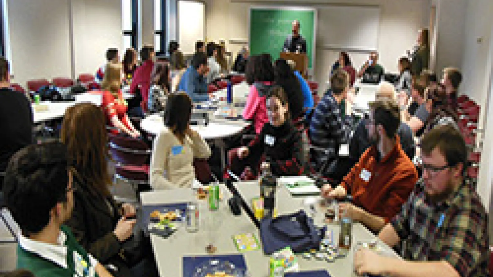 Students sitting around table talking to each other