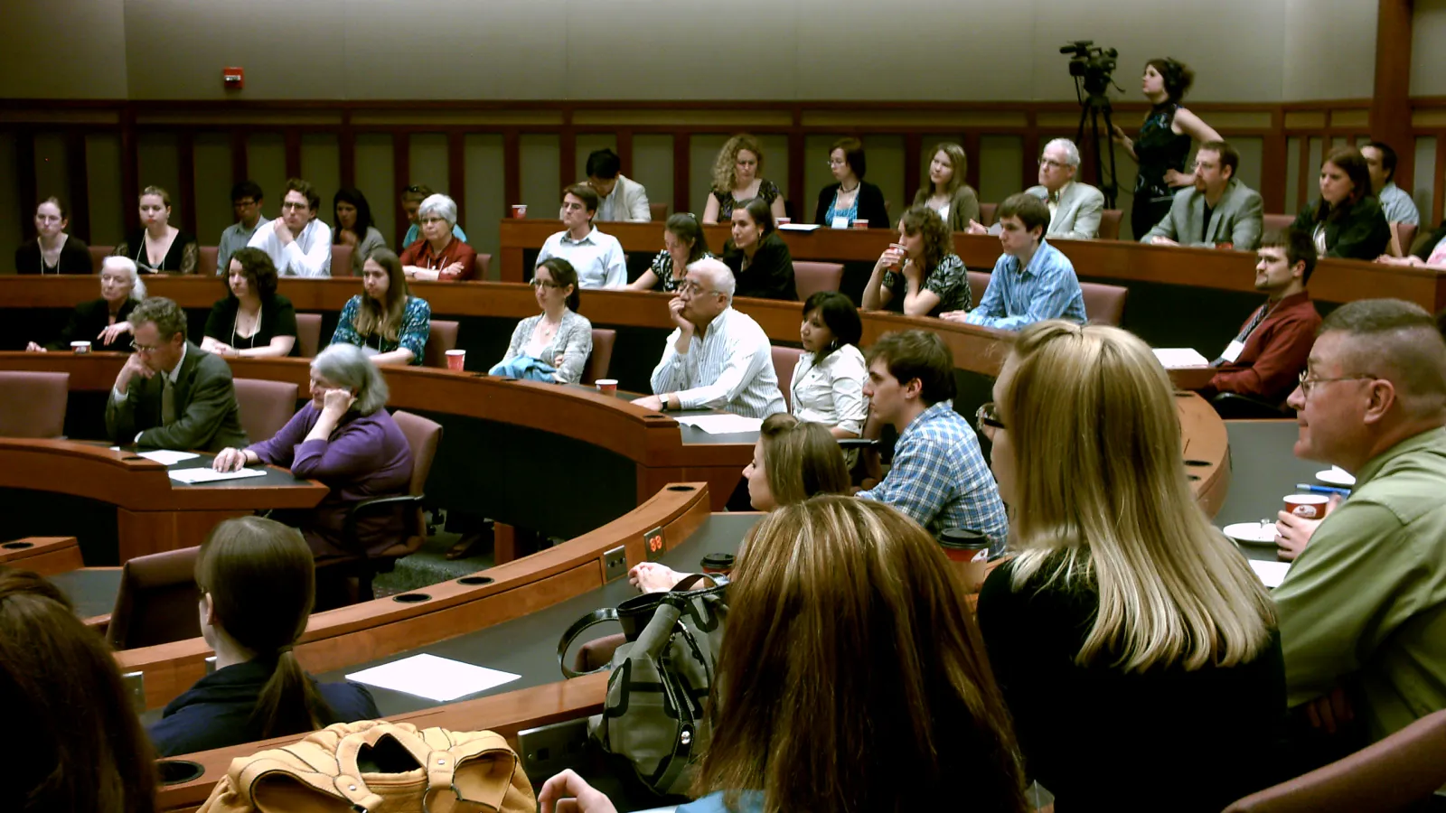 People sitting at U-shaped desks in a seminar room