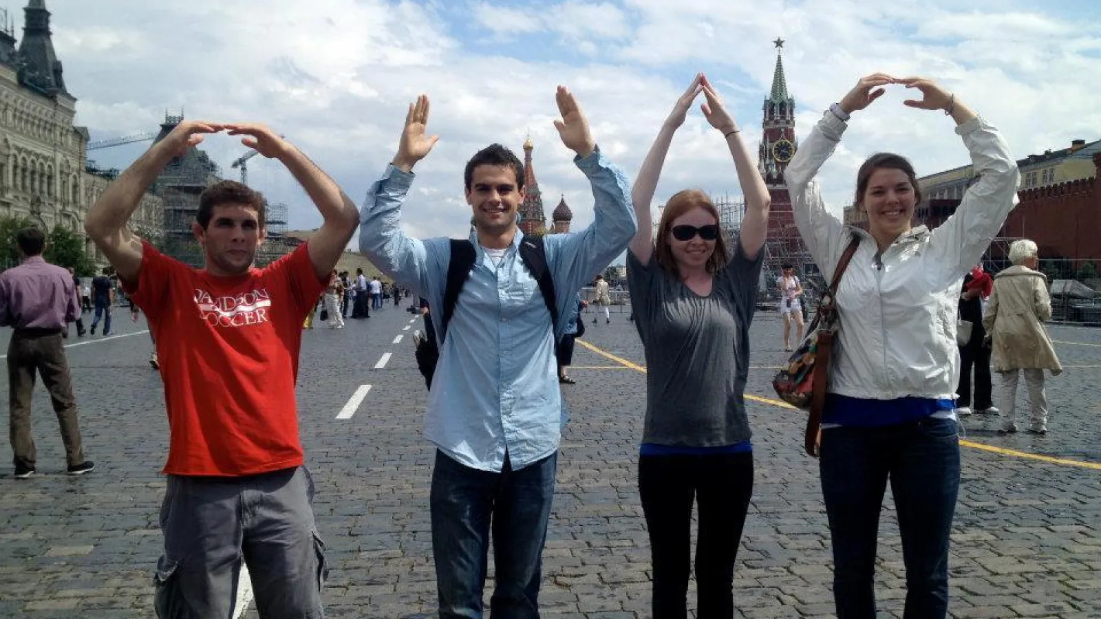 Four students standing side-by-side forming O-H-I-O
