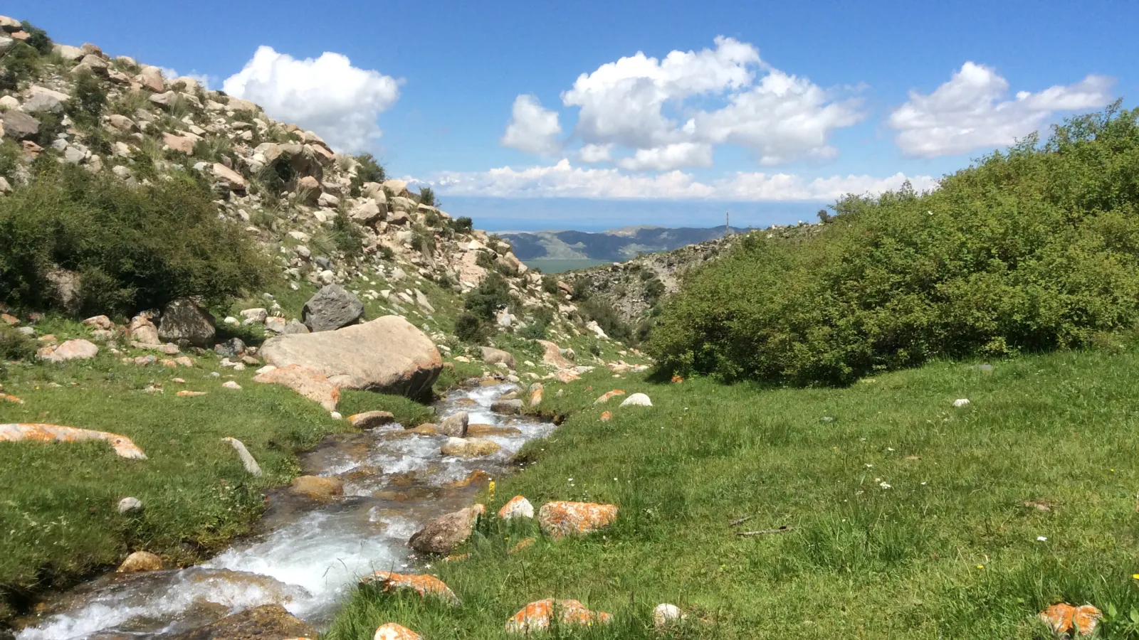 view of stream and Lake Issyk Kol in the distance