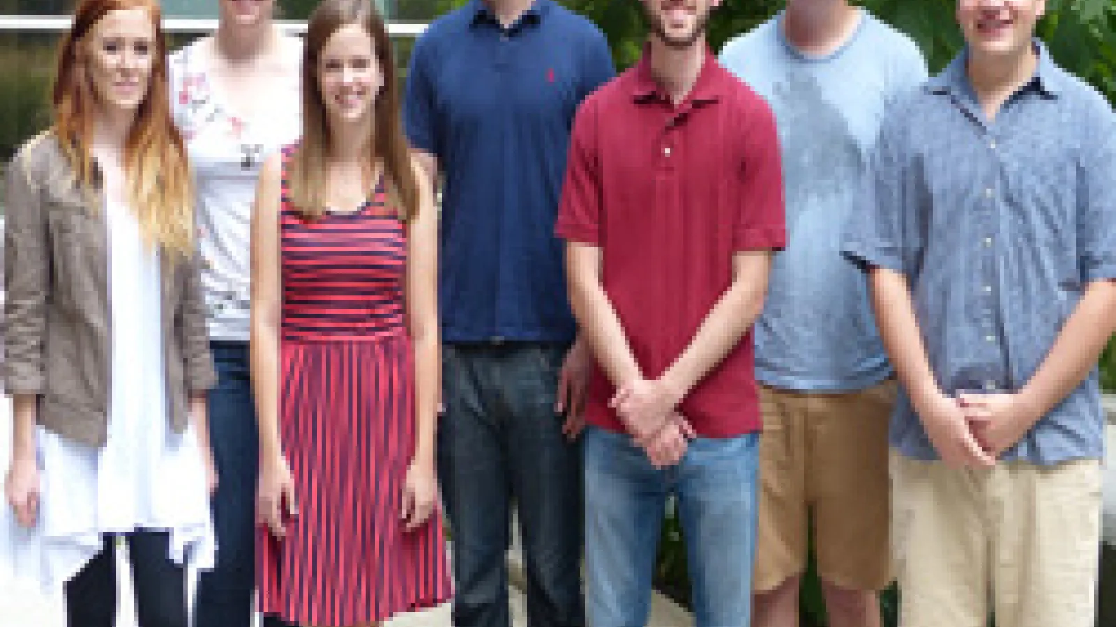 Two rows of students standing in a courtyard