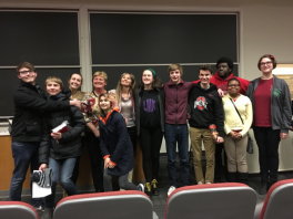 K12 Participants from Walnut Hills High School Students smiling and standing next to each other in the front of a classroom
