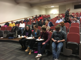 Students sitting in seats in a large auditorium