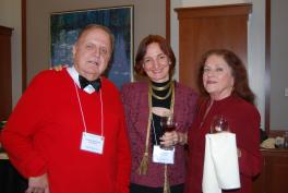 A man and two women standing should-to-should smiling