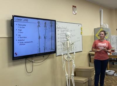 Lauren leading a session in a classroom.