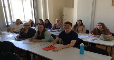 Students sitting at tables in rows