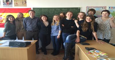 Large group of students standing in front of classroom