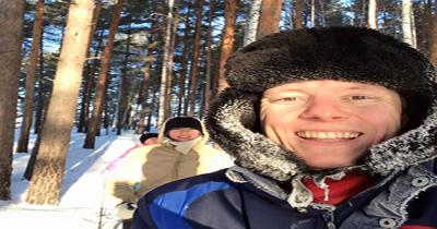 Eric at a Camp in Winter Head shot of a man with a fur hat on