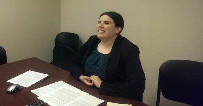 Dr. Ceilidh Orr Delivering Lecture to Howard University Woman sitting at desk speaking
