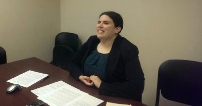 Woman sitting at desk speaking