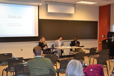 2017 Panel "Post-Soviet Continuity and Discontinuity" A woman and two men sitting at chairs behind a large table talking