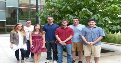 CSEES Class of 2014 Four men and three women standing in two rows in a courtyard