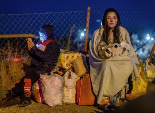 Helena (R) and her brother Bodia (L) from Lviv are seen at the Medyka pedestrian border crossing, in eastern Poland following the Russian invasion of Ukraine.