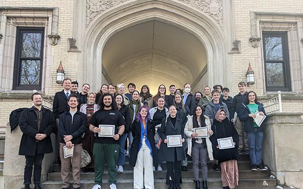 Paticipants in the 2024 Undergraduate Olympiada of Spoken Russian share their certificates in front of Kauke Hall at the College of Wooster