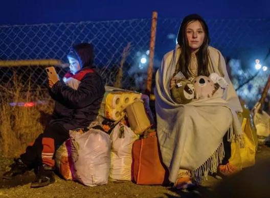 Helena (R) and her brother Bodia (L) from Lviv are seen at the Medyka pedestrian border crossing, in eastern Poland following the Russian invasion of Ukraine.