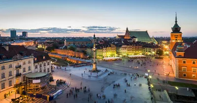 Aerial view of square in a city at night with buildings illuminated