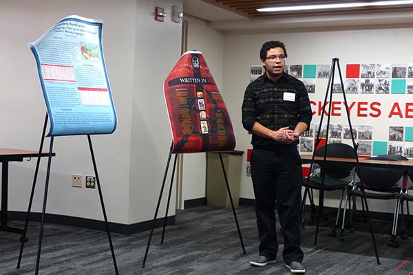 Student standing by poster