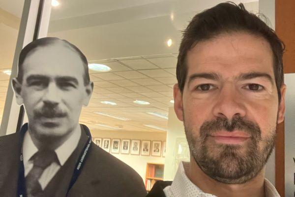 Artemy Kalinovsky (brown eyes, beard) poses in a museum with a cardboard cutout