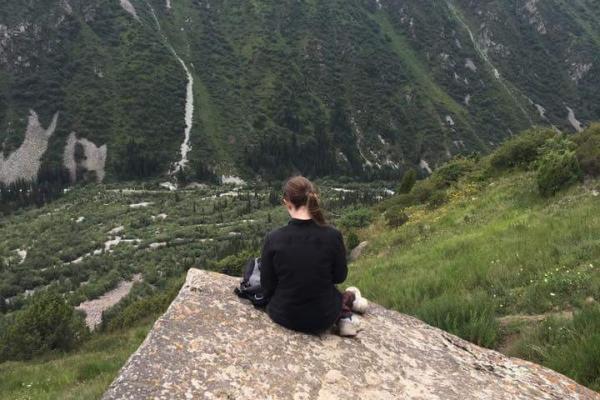 Amelia Smith enjoying the view off a mountain in Kyrgyzstan