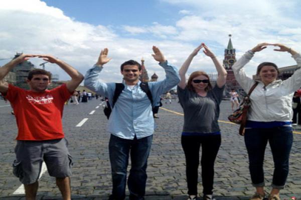 Four students standing side by side forming O-H-I-O