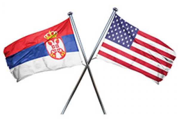 Serbian & US flags US flag hanging to the right, Serbian flag crossed over hanging to the left