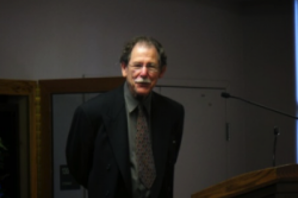 John Friedman John Friedman standing in a dark room