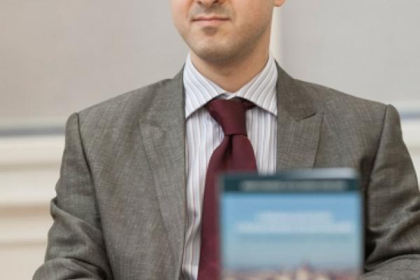 Dr. Umut Korkut at a desk