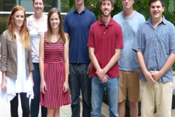 New MA Students Two rows of students standing in a courtyard