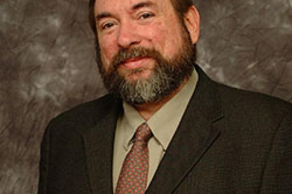 Closeup photo of man, torso up in a suit