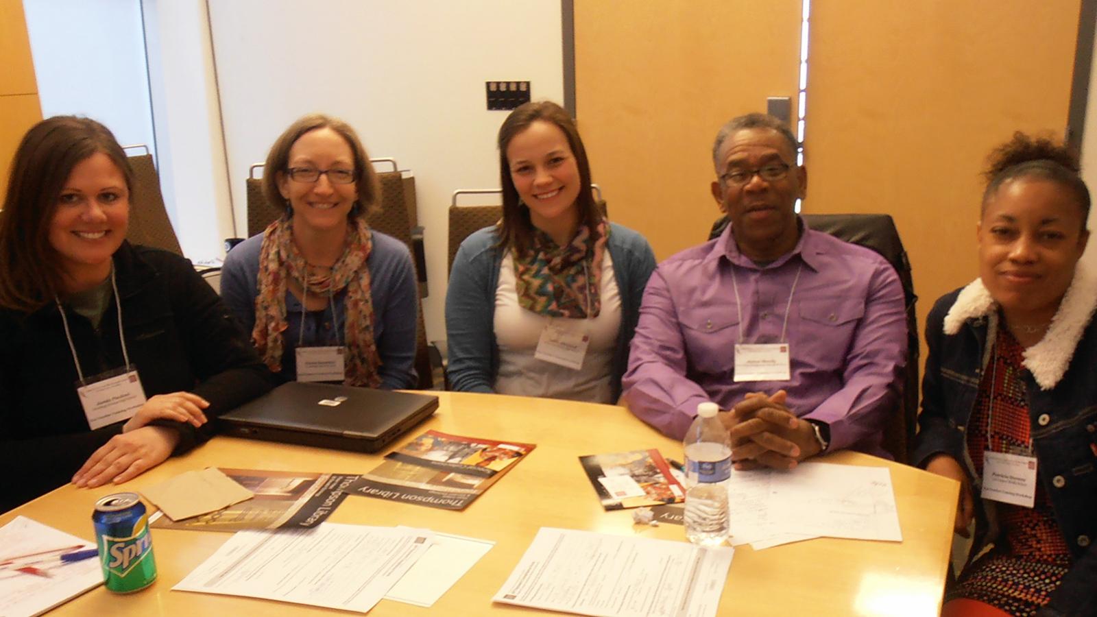 Five participants sitting at a table